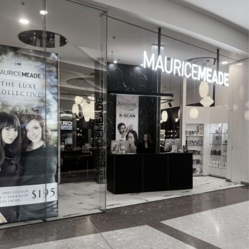 Maurice Meade store front showcasing The Luxe Collective with promotional banners.